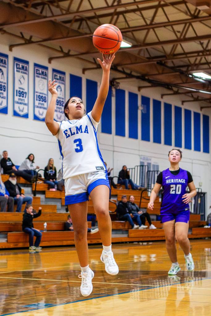 PHOTO BY MIKE ROBERTS Elmas Nency Guzman (3) scored eight points in the fourth quarter to lead the Eagles to a 52-49 victory over Heritage on Monday at Elma High School.