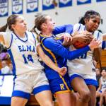 PHOTO BY MIKE ROBERTS Elmas Presley Skeem (14) and Keke Bol (right) compete for a loose ball during a 44-32 victory over Rochester on Wednesday in Elma.