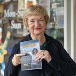 Kody Christen / The Chronicle
Author Sandy Crowell smiles for a photo with her new book The Ravaged Forest during an authors book signing event at Book n Brush in Chehalis on Saturday, Dec. 21. The book is available on Amazon.