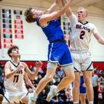 PHOTO BY MIKE ROBERTS Elmas Isaac McGaffey shoots against Teninos Austin Gonia during the Eagles 61-45 loss on Thursday in Tenino.