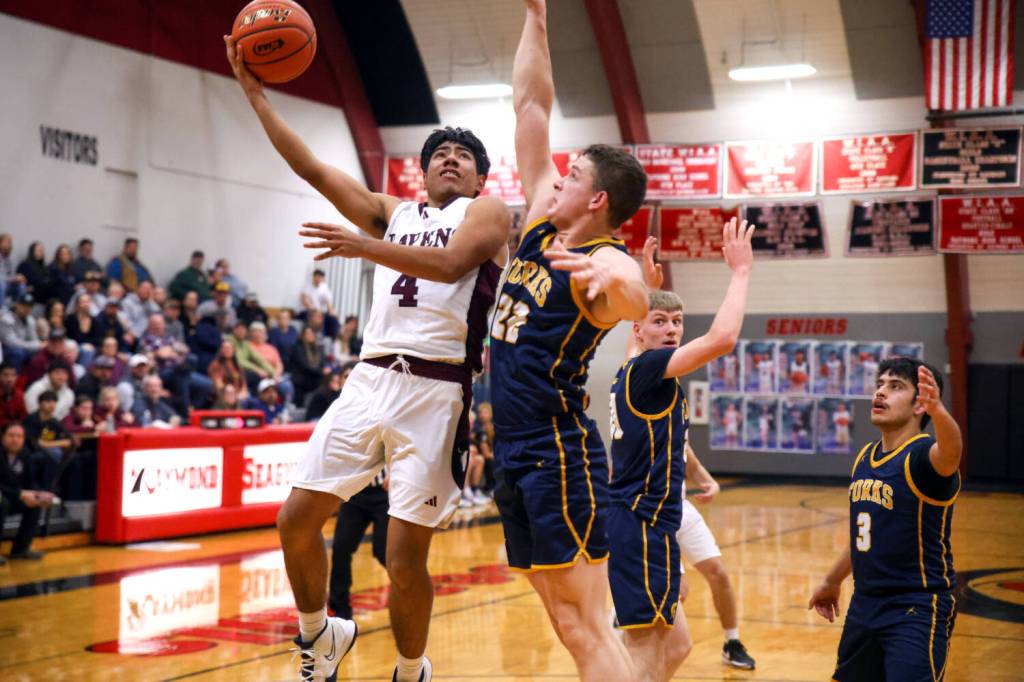 PHOTO BY LARRY BALE Raymond-South Bend senior guard Chris Quintana (4) shoots against Forks Brody Lausche during a 58-50 loss on Friday at Raymond High School.