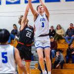 PHOTO BY MIKE ROBERTS Elmas Isaac McGaffey (3) puts up a shot against Rainiers Peyton Shaeffer during the Eagles 48-33 win on Monday at Elma High School.