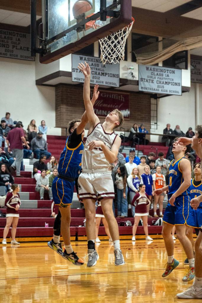 PHOTO BY FOREST WORGUM Montesanos Caden Grubb (foreground) scores two points during the Bulldogs 58-52 victory over Rochester on Tuesday at Montesano High School.
