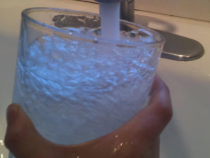 Water flows from a tap in this file photo. Three Southwest Washington cities are considering new restrictions on fluoride in drinking water. (Rebecca Roberts Galloway / OPB)