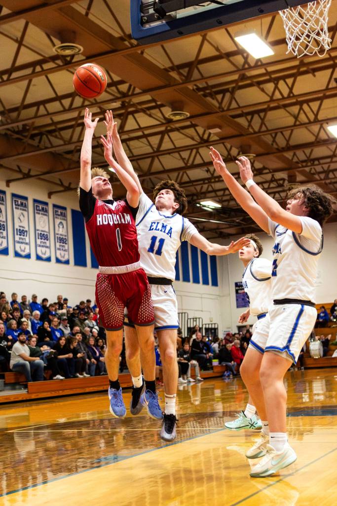 PHOTO BY MIKE ROBERTS Hoquiams Ryker Maxfield (1) is defended by Elmas Matthew Wood (11) during the Eagles 66-54 win on Thursday at Elma High School. Maxfield scored 20 points to lead the Grizzlies.
