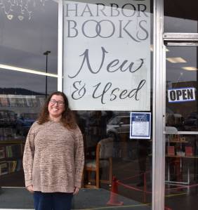 The owner of Harbor Books, Melinda Einander, poses for a photo outside her shop. (Jerry Knaak photos / The Daily World)