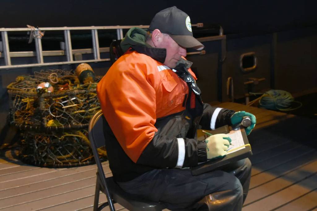 WDFW coastal shellfish technician Clayton Parson records data during a test fishing trip out of Westport. (WDFW)