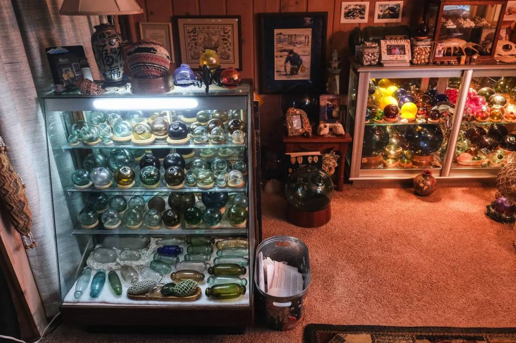 Alan Rammer’s collection of glass floats includes rare and valuable finds from his years of beachcombing around the world. He has cases full of them in his home. (Dean Rutz / The Seattle Times)