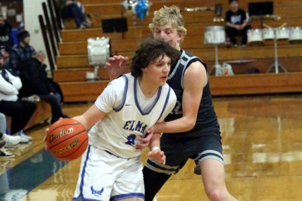 RYAN SPARKS | THE DAILY WORLD Elmas Tanner Moe (left) gets around Montesano defender Mason Fry during the Eagles 47-37 win on Wednesday at Elma High School.