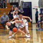 RYAN SPARKS | THE DAILY WORLD Montesanos Terek Gunter (left) and Elmas Theo Flores compete for a loose ball during the Eagles 47-37 win on Wednesday at Elma High School.