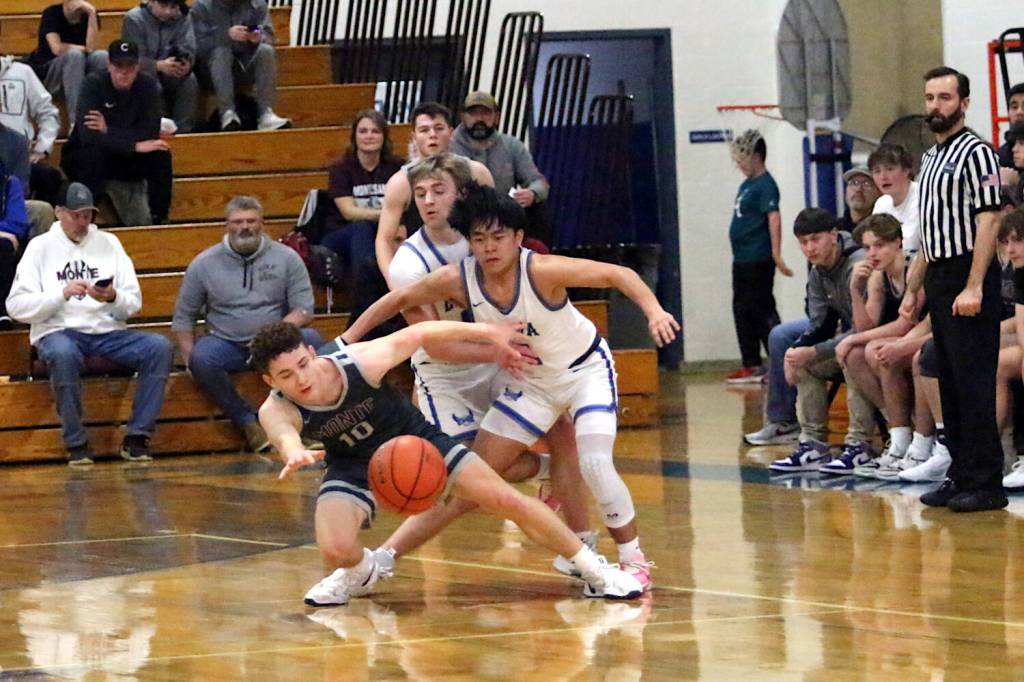 RYAN SPARKS | THE DAILY WORLD Montesanos Terek Gunter (left) and Elmas Theo Flores compete for a loose ball during the Eagles 47-37 win on Wednesday at Elma High School.