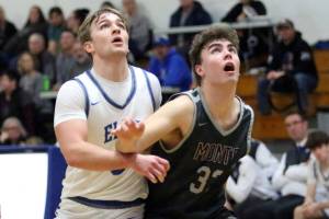 RYAN SPARKS | THE DAILY WORLD Elmas Traden Carter (left) and Montesanos Nathan Dowler ready for a rebound during the Eagles 47-37 win on Wednesday at Elma High School.