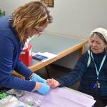 Grays Harbor County Public Health Nurse Lena Stoddard prepares to test the blood sugar of an Elma resident. (Jerry Knaak photos / The Daily World)