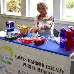 Non-medical volunteer Sue Bucy sets up a table in the Elma Timberland Library’s conference room.