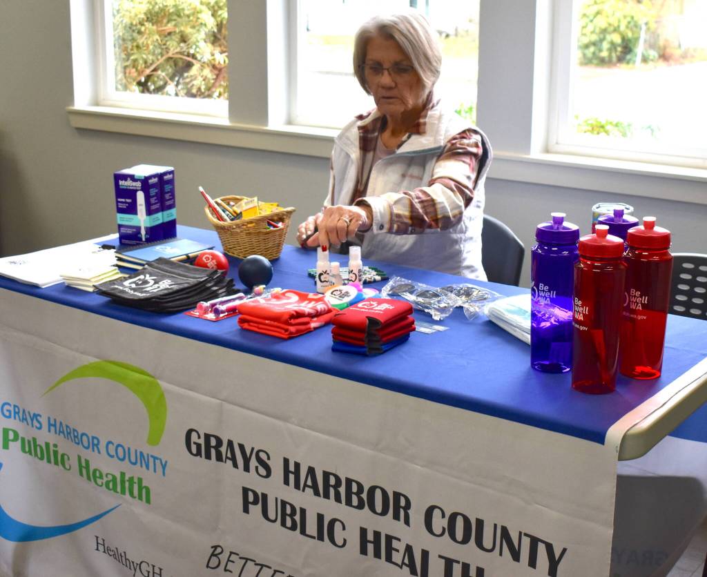 Non-medical volunteer Sue Bucy sets up a table in the Elma Timberland Library’s conference room.