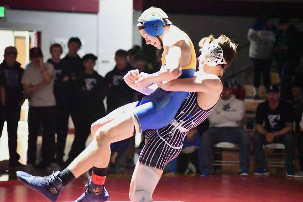 PHOTO BY SUE MICHALAK BUDSBERG Elmas Troy Rupe (right) lifts Rochesters Maddox King during the 138-pound title match of the 1A District 4 EvCo tournament on Saturday at Hoquiam High School.