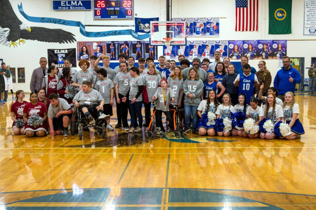PHOTO BY JOHN GUERRERO Members of the Elma and Hoquiam Unified teams pose for a photo after a game on Thursday at Elma High School.