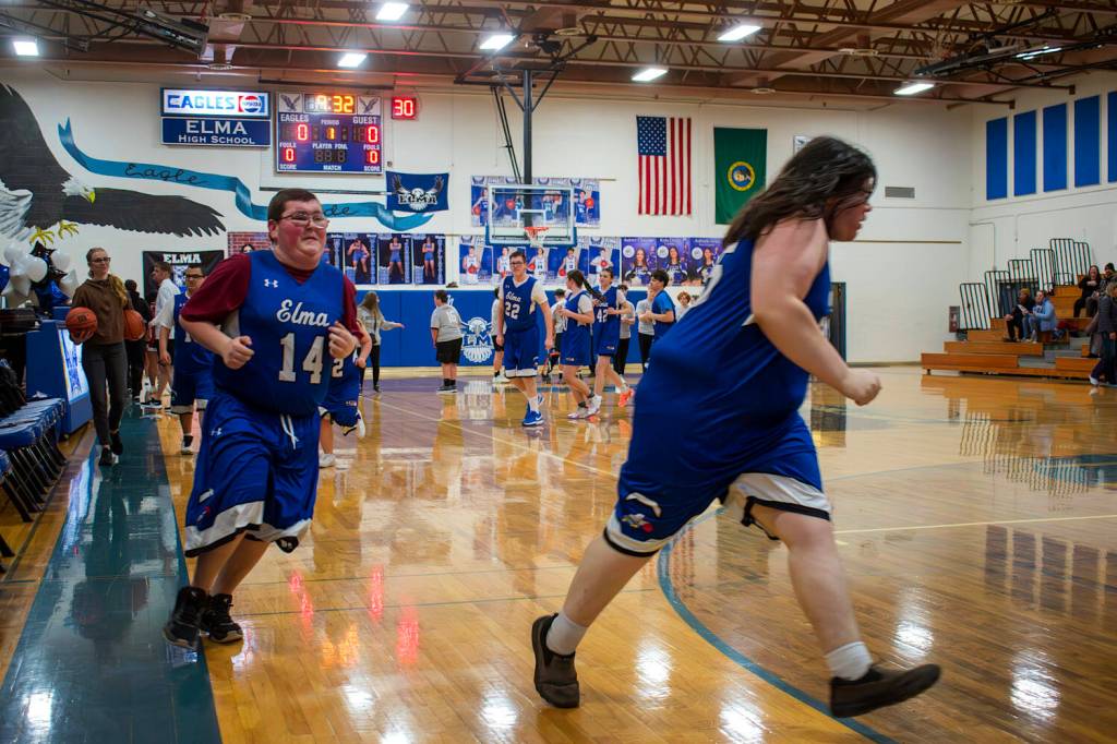 PHOTO BY JOHN GUERRERO Members of the Elma Unified team warm up ahead of a game against Hoquiam on Thursday at Elma High School.