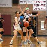 PHOTO BY FOREST WORGUM 
Montesanos Ava Schrader (left) and Tieander Olson surround a Kalama player during the Bulldogs 74-40 win in the 1A District 4 Tournament on Wednesday at Montesano High School.