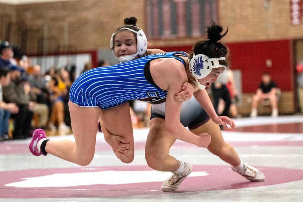 PHOTO BY FOREST WORGUM Montesanos Angelina Brunzie (background) wrestles against Elmas Kailynn Brown in a 130-pound semifinal match at the 1B/2B/1A District 4 Championships on Saturday at Montesano High School.