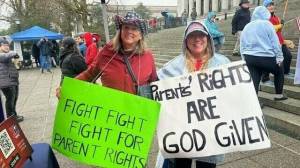 Carleen Johnson / The Center Square
Two rally-goers in Olympia on Saturday.
