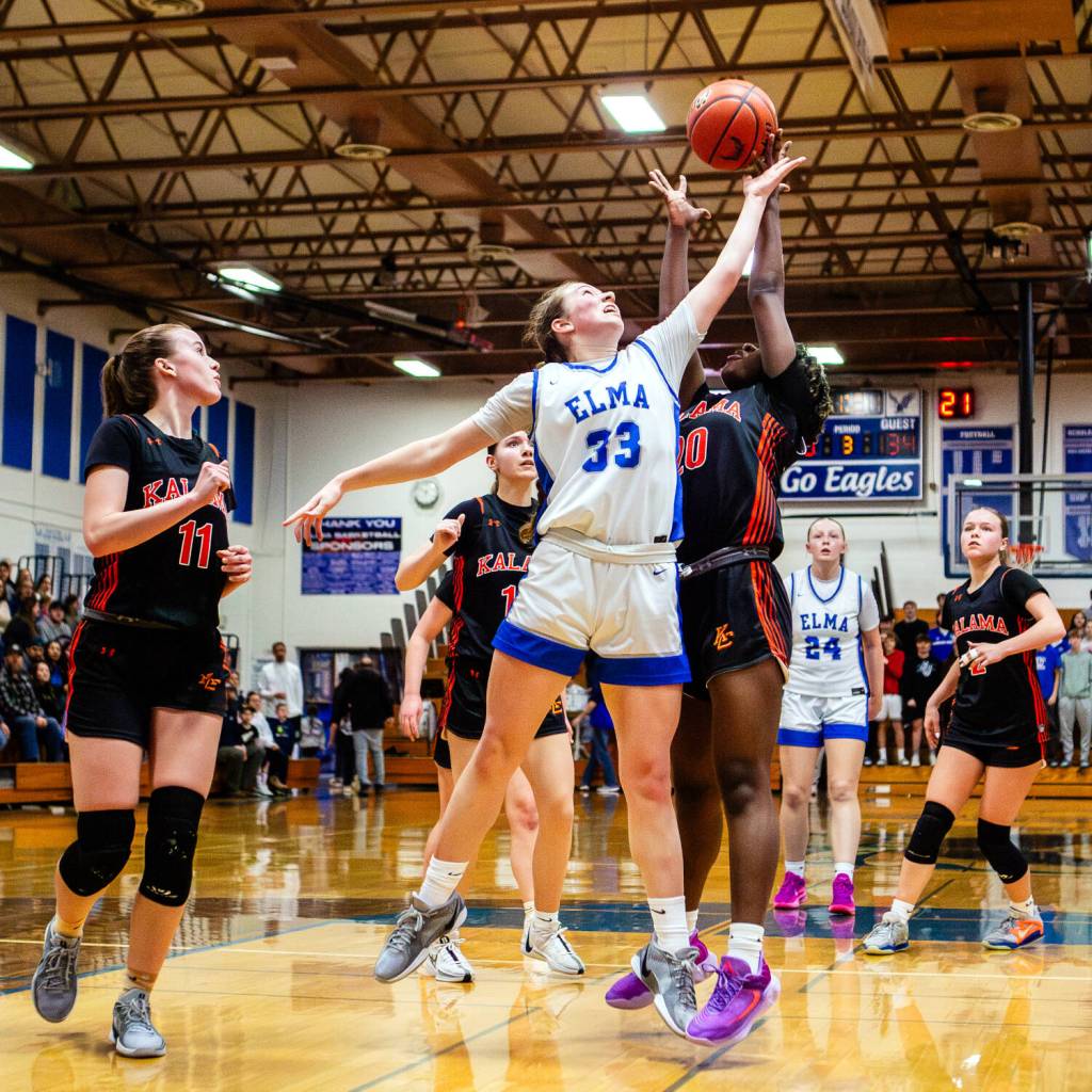PHOTO BY MIKE ROBERTS Elma junior Olivia Moore (33) competes for a rebound against Kalamas Hannah Johnson during the Eagles 52-42 loss in a 1A District 4 elimination game on Tuesday at Elma High School.