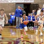 RYAN SPARKS | THE DAILY WORLD Elma guard Theo Flores (middle) races away from Montesanos Caden Grubb (23) and Terek Gunter during the Eagles 49-48 victory on a 1A District 4 elimination game on Wednesday at Montesano High School.