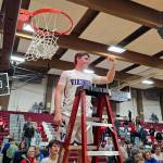 RYAN SPARKS | THE DAILY WORLD Willapa Valley guard Lucas Lusk holds a piece of the net after a 46-44 win over Ocosta in the 1B District 4 title game on Saturday in Montesano.