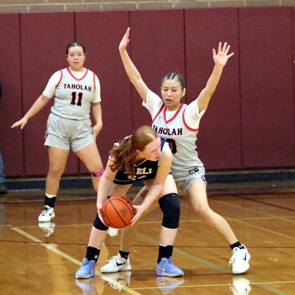 RYAN SPARKS | THE DAILY WORLD Taholahs Keeliana McCrory (right) defends Pe Ells Brookelynn King while teammate Luvaila Smith (11) looks on during Taholahs 50-38 loss in the 1B District 4 championship game on Saturday at Montesano High School.