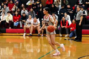 PHOTO BY TIA CHENEY Taholah guard Maliah Pluff surveys the floor during a 58-35 win over Evergreen Lutheran in the opening round of the 1B State Tournament on Tuesday at Taholah High School.