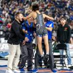 COHEN ANDERSEN | MATFOCUS.COM Elmas Xavier Espinoza (foreground) leaps into the arms of his coaches after winning the 113-pound state title at the Mat Classic XXXVI on Saturday at the Tacoma Dome.