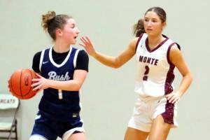 RYAN SPARKS | THE DAILY WORLD Montesanos Jordyn Perry (right) defends The Bush Schools Elise Fischer during the Bulldogs 47-19 victory in a 1A State Tournament game on Saturday at W.F. West High School.