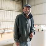 F/V Fury owner and captain Mike Harris, of Westport, on right, looks on as his vessel is lowered back into the water by a mobile travel lift following a three-week trip to the Ilwaco Boatyard for repairs in preparation for the upcoming charter fishing season.