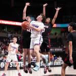 PHOTO BY TIA CHANNELL Willapa Valleys Lucas Lusk (middle) puts up a shot against Tulalip Heritages David Bachand (12) and Jaylan Gray (3) during a 64-46 loss in the 1B State Tournament fourth/sixth-place game on Saturday at the Spokane Arena.