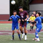 RYAN SPARKS | THE DAILY WORLD Raymond-South Bends Chris Quintana (4) heads the ball during a scrimmage against the Elma Eagles at the Montesano Boys Soccer Jamboree on Monday at Montesano High School.