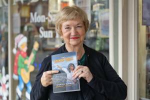 Kody Christen / The Chronicle
Author Sandy Crowell smiles for a photo with her new book The Ravaged Forest. Join Crowell at 1 p.m. on April 5 for a book talk and signing.