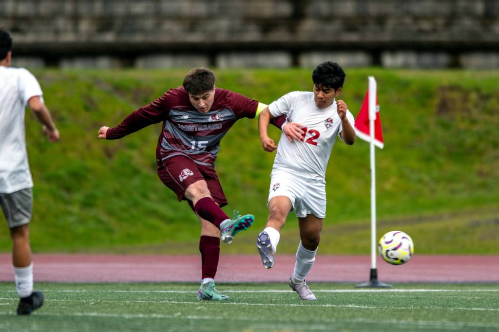 PHOTO BY FOREST WORGUM Montesano forward Felix Romero (15) scores a goal while defended by Hoquiams Gilbert Rodriguez Madrigal during Montes 6-3 win on Tuesday in Montesano.