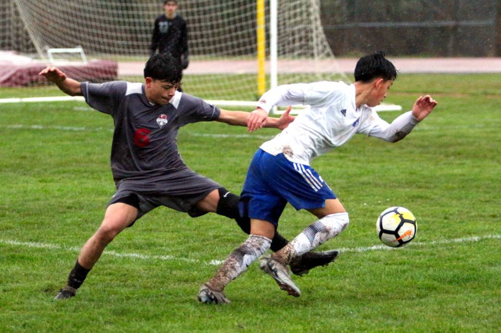 RYAN SPARKS | THE DAILY WORLD Elmas Ivan Rodriguez (right) is defended by Hoquiams Israel Rosales during the Eagles 5-2 win on Thursday at the Sea Breeze Oval in Hoquiam.