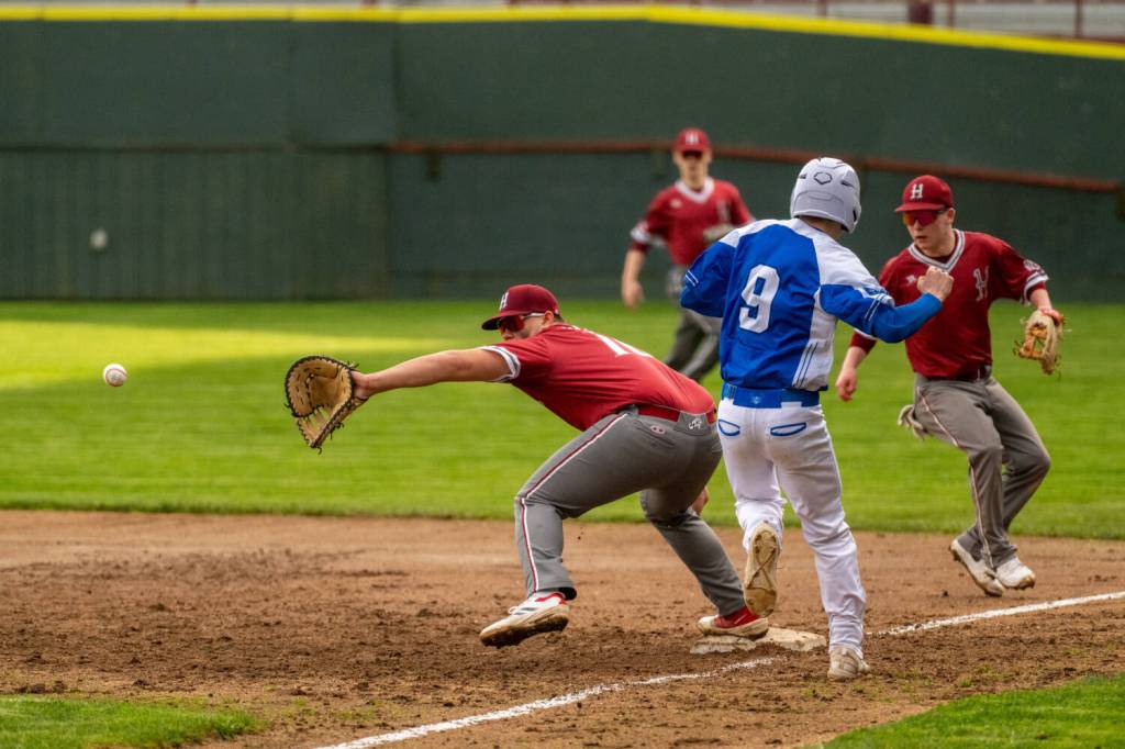 PHOTO BY FOREST WORGUM Hoquiam first baseman Ryan Pullar (left) fields a throw as Elmas Colt Landstrom races to first base during the Eagles 10-0 win on Tuesday at Olympic Stadium in Hoquiam.