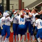 RYAN SPARKS | THE DAILY WORLD Elma third baseman Lynsee Bednarik (10) is congratulated by her teammates after hitting a home run in the second inning of a 19-6 win over Hoquiam on Thursday in Montesano.