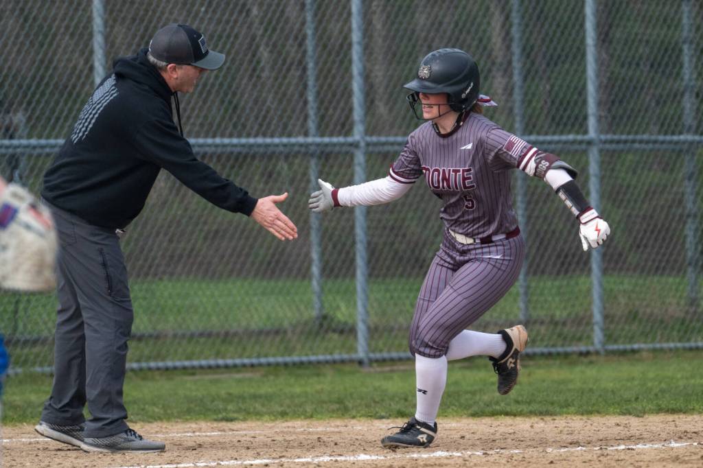 PHOTO BY FOREST WORGUM 
Montesanos Grace Gooding (right) is congratulated by Bulldogs head coach Pat Pace after hitting a home run during a game against Elma on Tuesday in Elma.