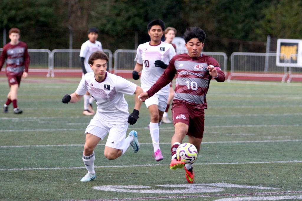 RYAN SPARKS | THE DAILY WORLD Montesanos Cris Tobar boots the ball forward while pursued by Raymond-South Bends Alex Posada during the Ravens 6-0 win on Thursday at Jack Rottle Field in Montesano.