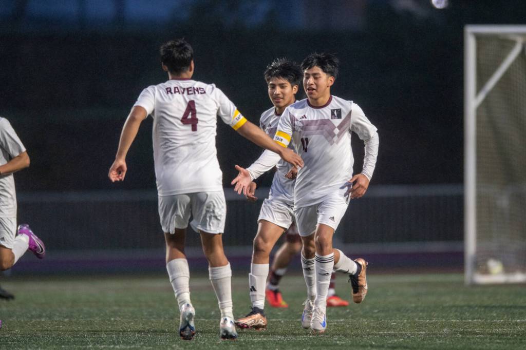 PHOTO BY FOREST WORGUM Raymond-South Bends Edgar Ramirez (11) is congratulated by teammate Chris Quintana (4) during the Ravens 6-0 win on Thursday at Jack Rottle Field in Montesano.