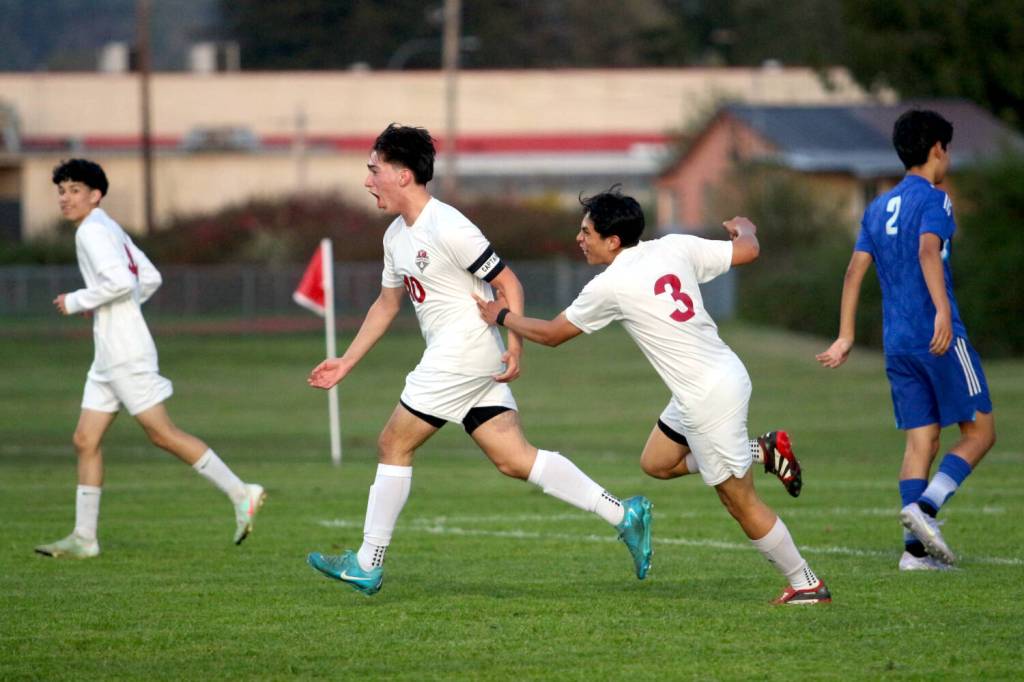 RYAN SPARKS | THE DAILY WORLD Hoquiam midfielder Michael Garcia (10) celebrates with teammate Ulises Morelia (3) after scoring a goal in the second half of a win over Elma on Thursday in Elma.
