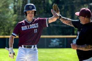 PHOTO BY FOREST WORGUM Montesanos Kole Kjesbu (11) receives congratulations during a win over Tenino in a doubleheader on Friday at Vessey Field in Montesano.