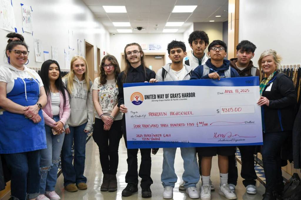 Kelley McDonald, right, the executive director of United Way of Grays Harbor, presents a $4,305 check to the Aberdeen High School culinary students who staffed the 2025 United Way Gala fundraiser in January.