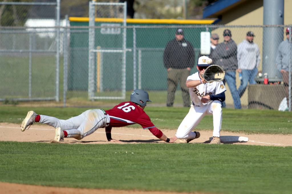 RYAN SPARKS | THE DAILY WORLD Aberdeen first baseman Aidan Baker (right) catches a pick-off attempt against W.F. Wests Deacon Meller during a 7-2 loss on Tuesday in Aberdeen.