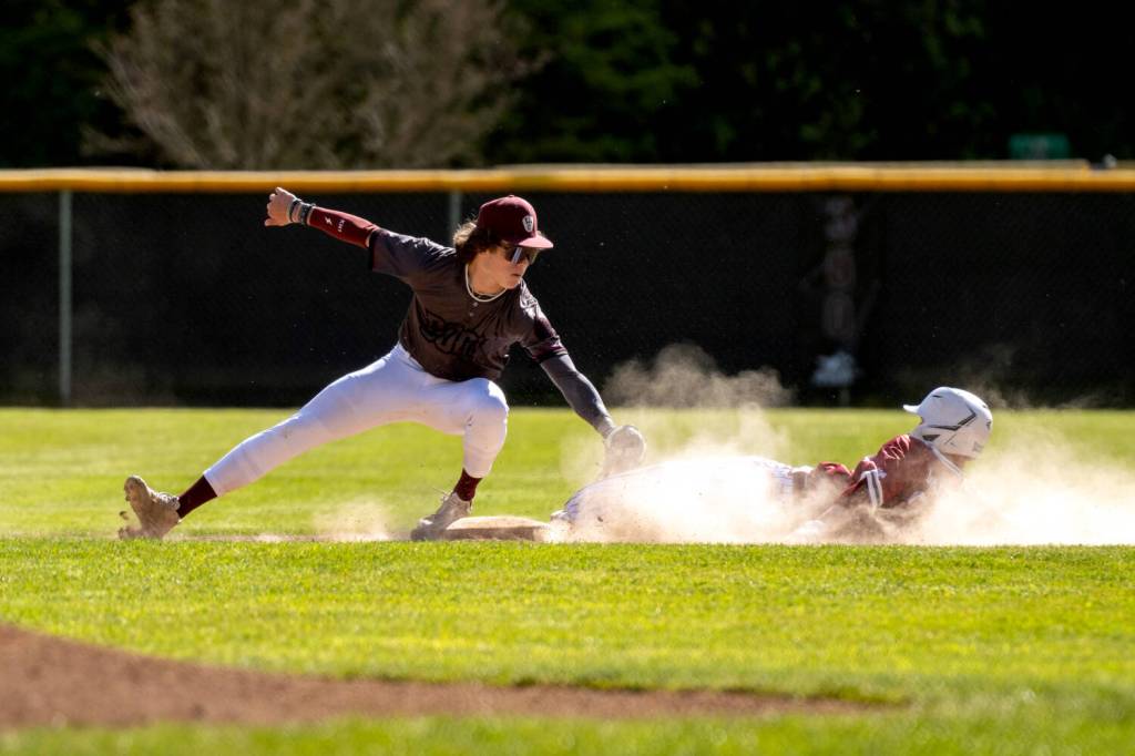 PHOTO BY FOREST WORGUM Montesano infielder Kolson Hendrickson (left) tags out a runner during a 2-1 win over Hoquiam on Tuesday in Montesano.
