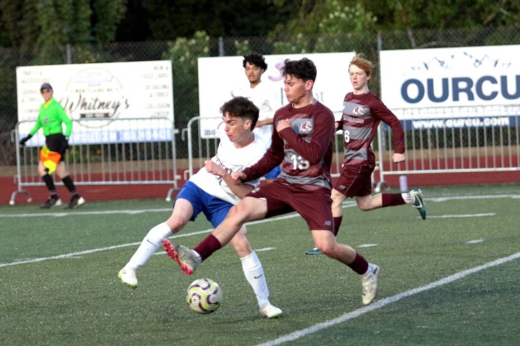 RYAN SPARKS | THE DAILY WORLD Montesanos Nolan Swenson (right) dribbles through the midfield during a 1-0 loss to Rochester on Tuesday at Montesano High School.
