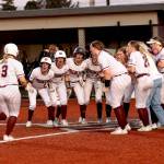 PHOTO BY HAILEY BLANCAS Montesano catcher Ali Parkin (3) is greeted by her teammates after hitting a game-winning home run in a 7-6 win over Rochester on Thursday at Dick Tagman Field in Montesano.
